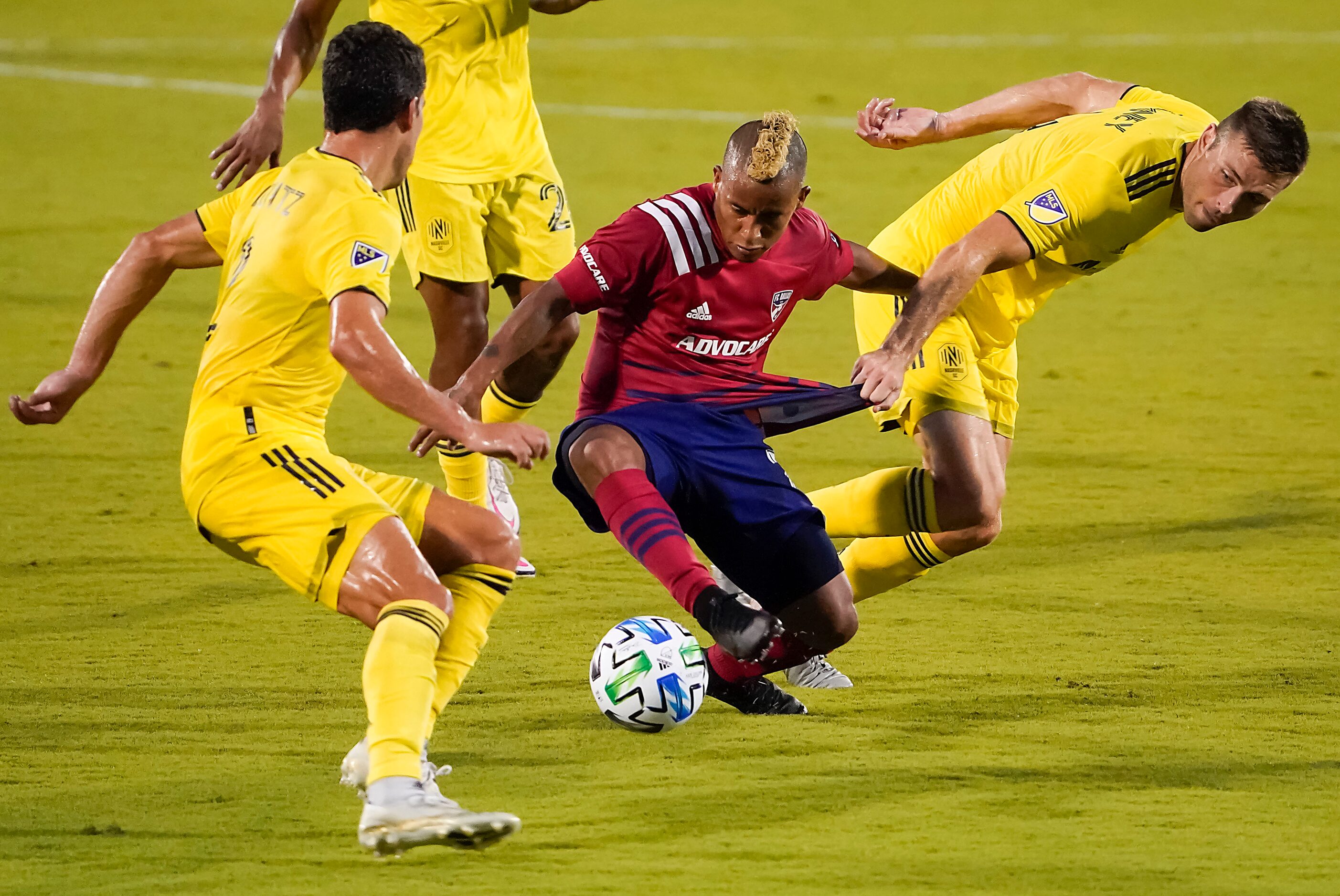 FC Dallas midfielder Michael Barrios (21) has his jersey pulled by Nashville SC defender...