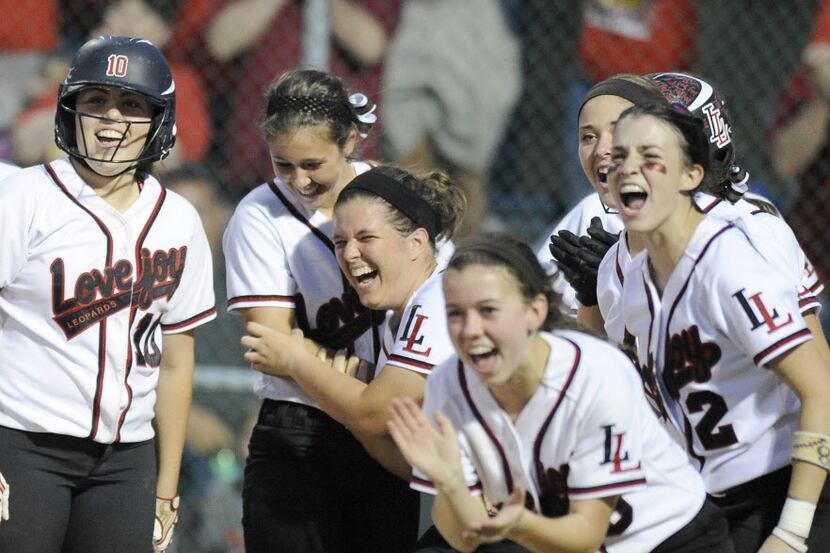 Lovejoy players wait at home plate for Amanda Gray after her home-run during a Class 4A...