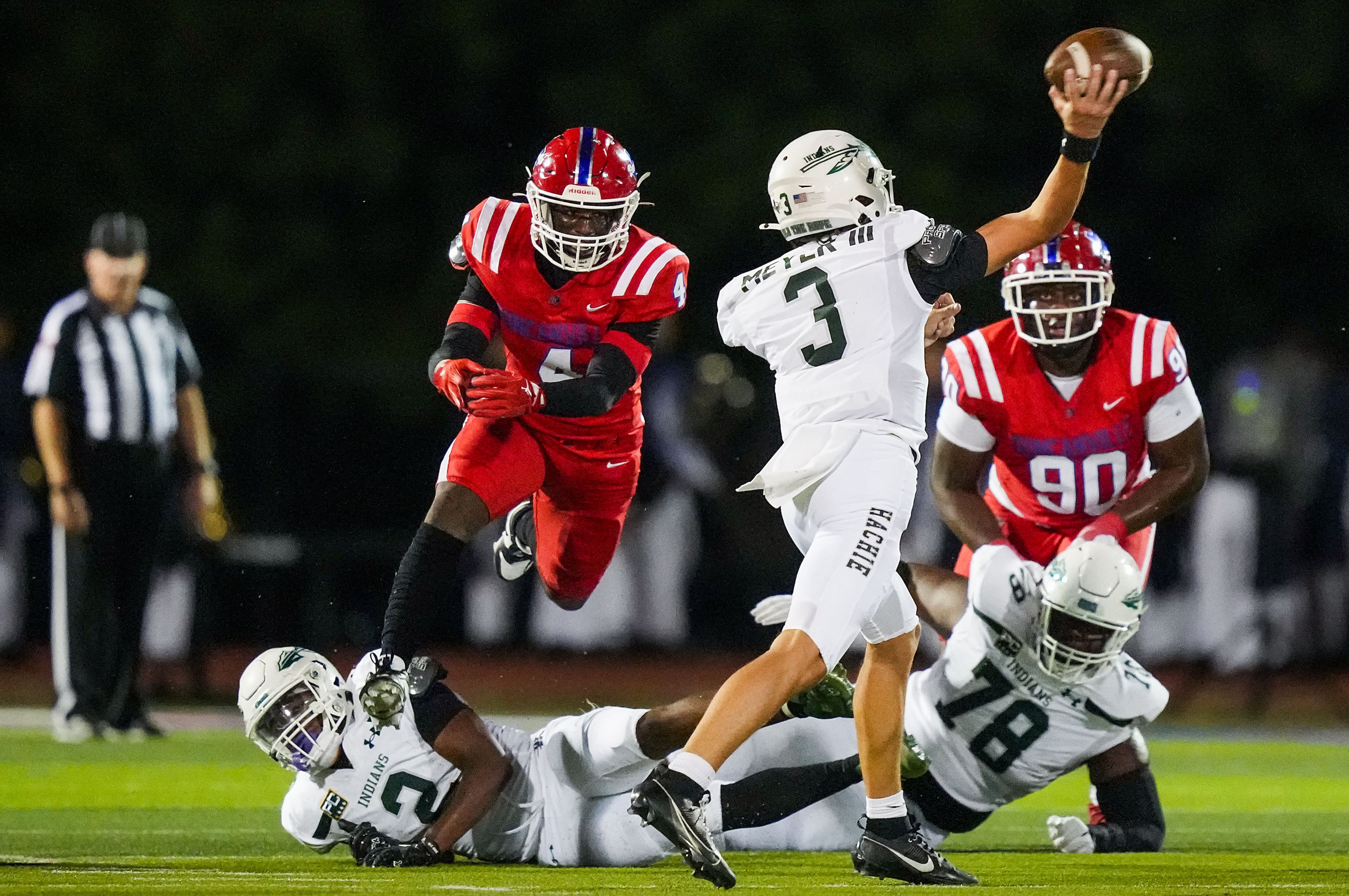 Waxahachie quarterback Jerry Meyer III (3) throws a pass under pressure from Duncanville...