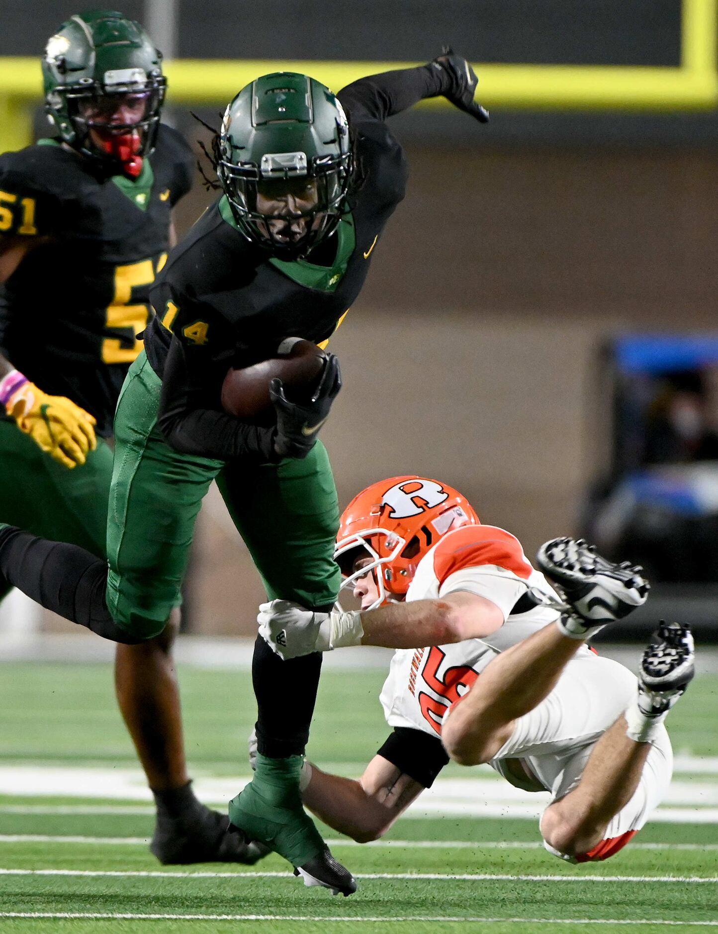 DeSoto’s Robert Richardson eludes the tackle attempt by Rockwall’s Corey Kelley (25) in the...