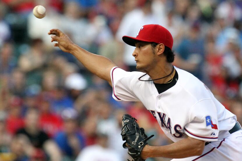 Texas Rangers starting pitcher Yu Darvish (11) throws a first-inning pitch during the...