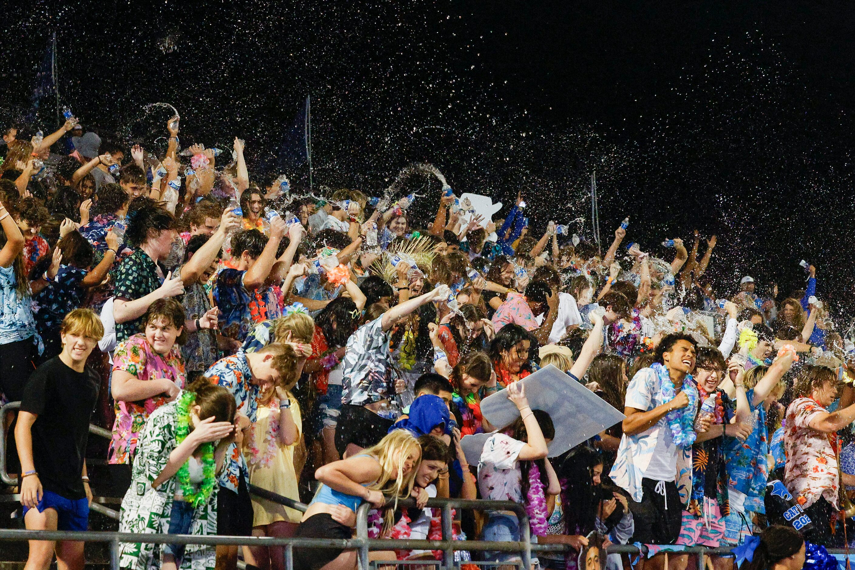 Trophy Club Byron Nelson celebrate a touchdown by throwing water in the air during the...