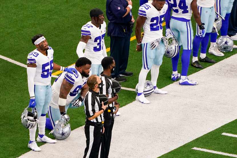 Dallas Cowboys defensive tackle Dontari Poe (95) kneels for the national anthem alongside...