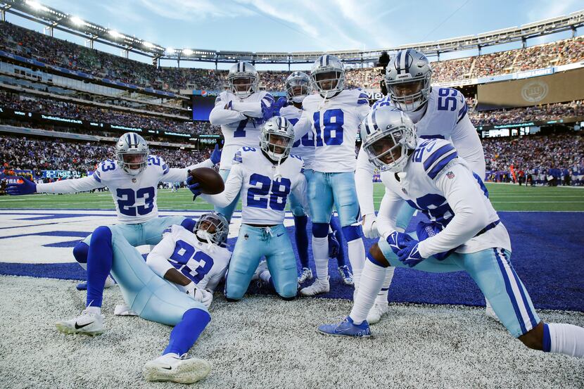Dallas Cowboys safety Malik Hooker (28) and his defensive teammate pose for a photo after...