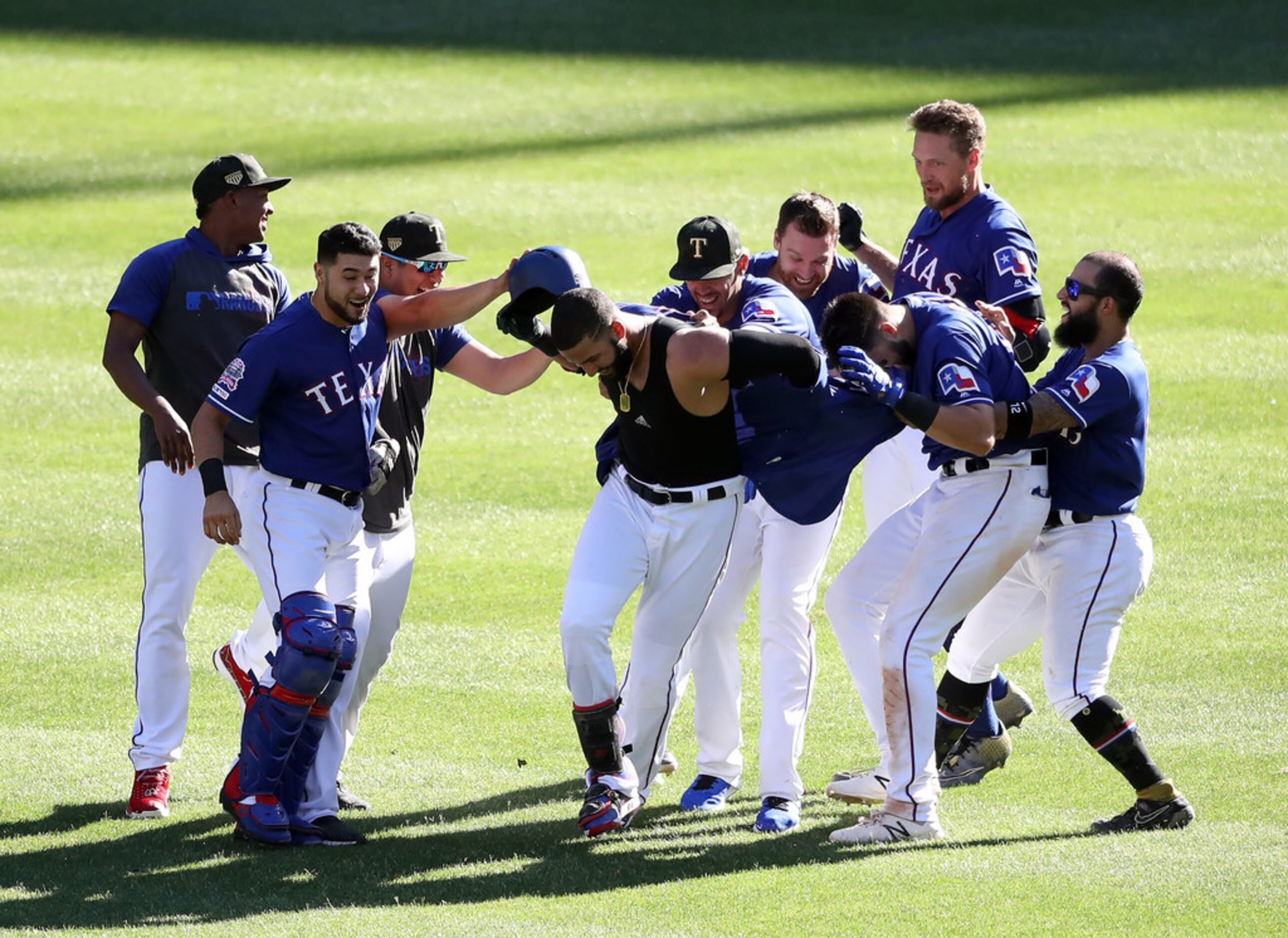 ARLINGTON, TEXAS - MAY 19:  The Texas Rangers celebrate the game winning run scored on a...