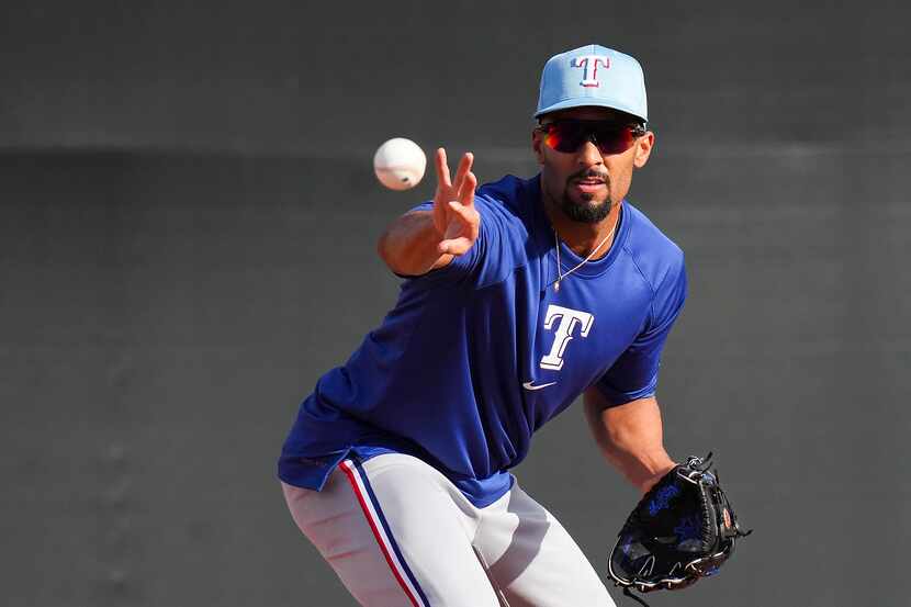 Texas Rangers infielder Marcus Semien participates in a fielding drill during a spring...