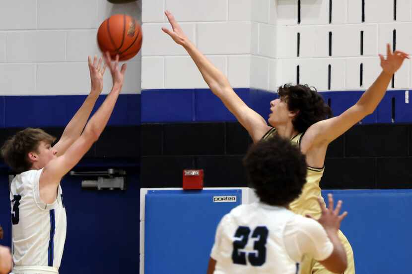 Plano West guard Walker Williams (3), 2nd from left, scores on a 3-pointer over the defense...