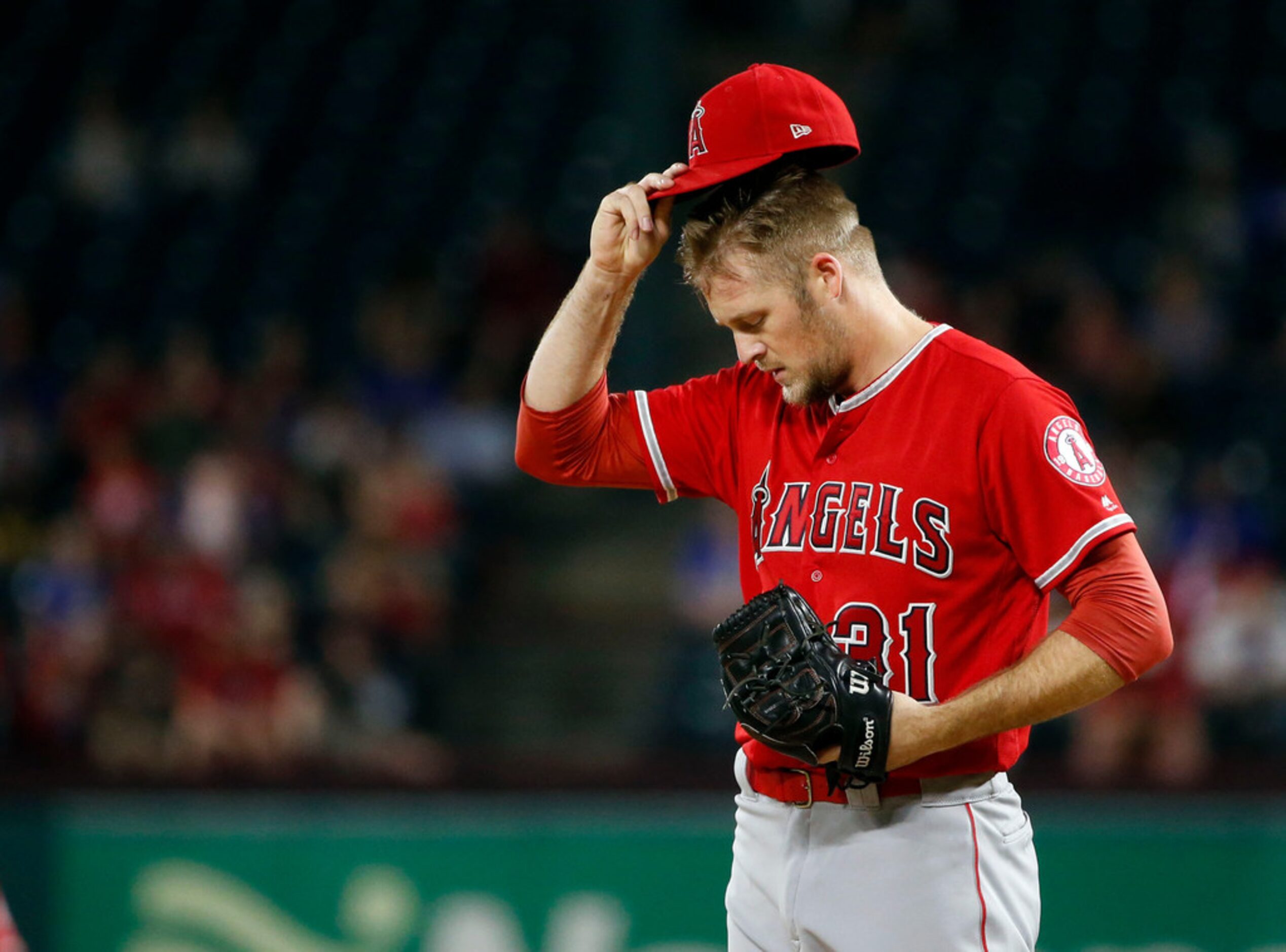 Los Angeles Angels  relief pitcher Ty Buttrey (31) composes himself after allowing a run...