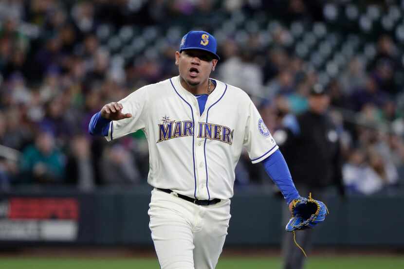 Seattle Mariners starting pitcher Felix Hernandez lets out a yell after striking out Oakland...