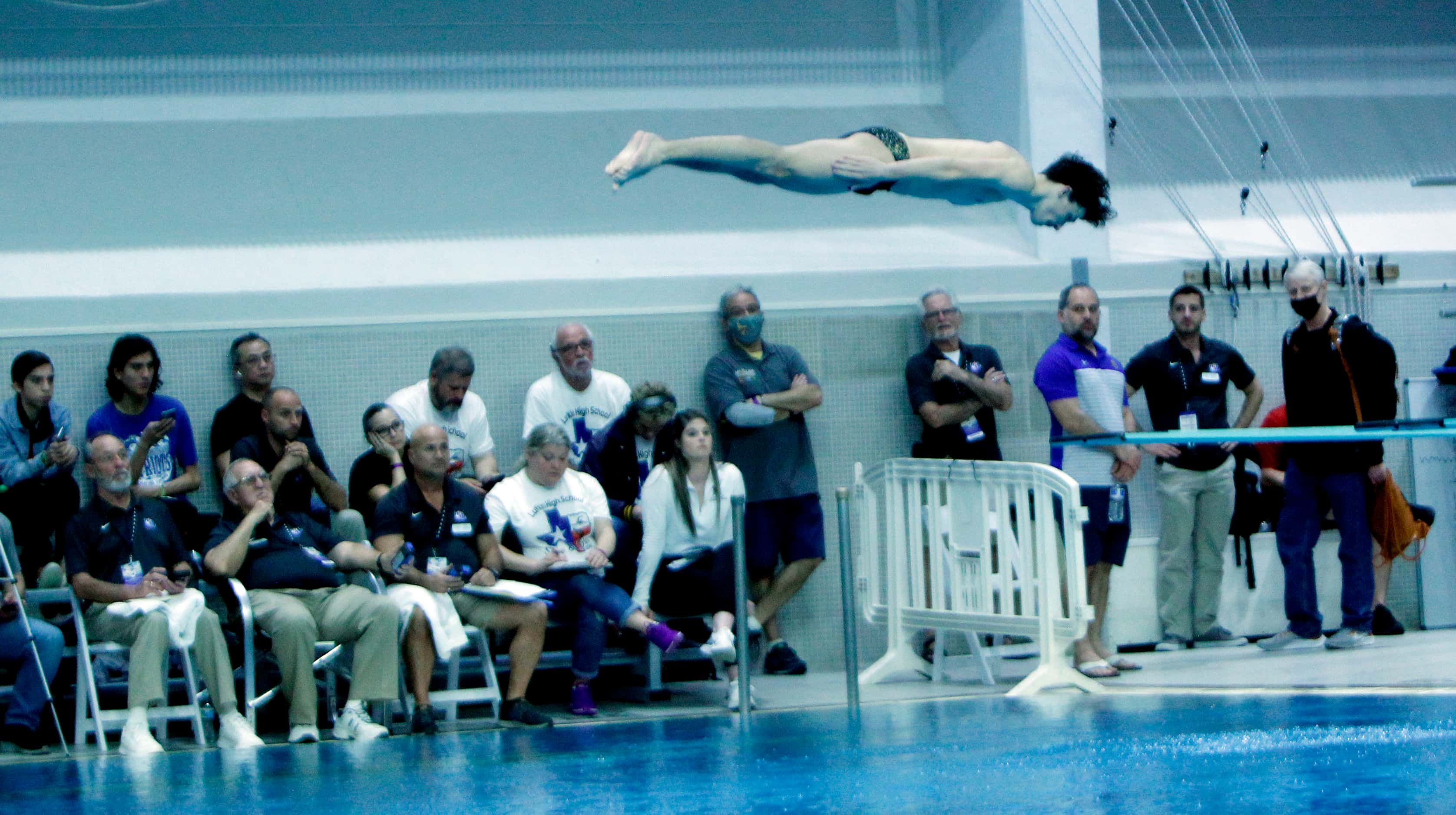Forney diver Bryce Benson appears to levitate above the water as judges and fans watch his...