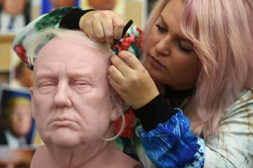 Sophie Crudgington inserts Yak hairs onto an unfinished wax figure of President-elect Donald...