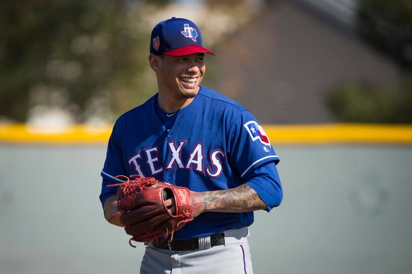 Texas Rangers pitcher Keone Kela laughs while taking fielding practice during a spring...