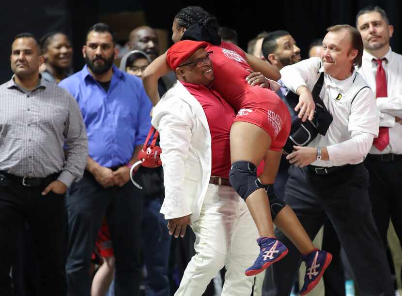 Kimball junior wrestler Destiny Miles embraces coach Devon Fortson after she won the UIL...