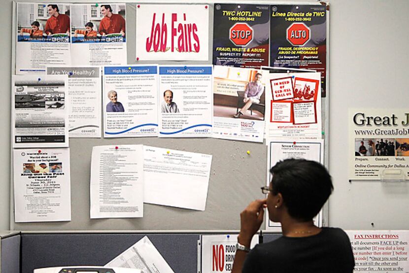 A job seeker looks at a bulletin at the Texas Workforce Commission's Workforce Solutions of...