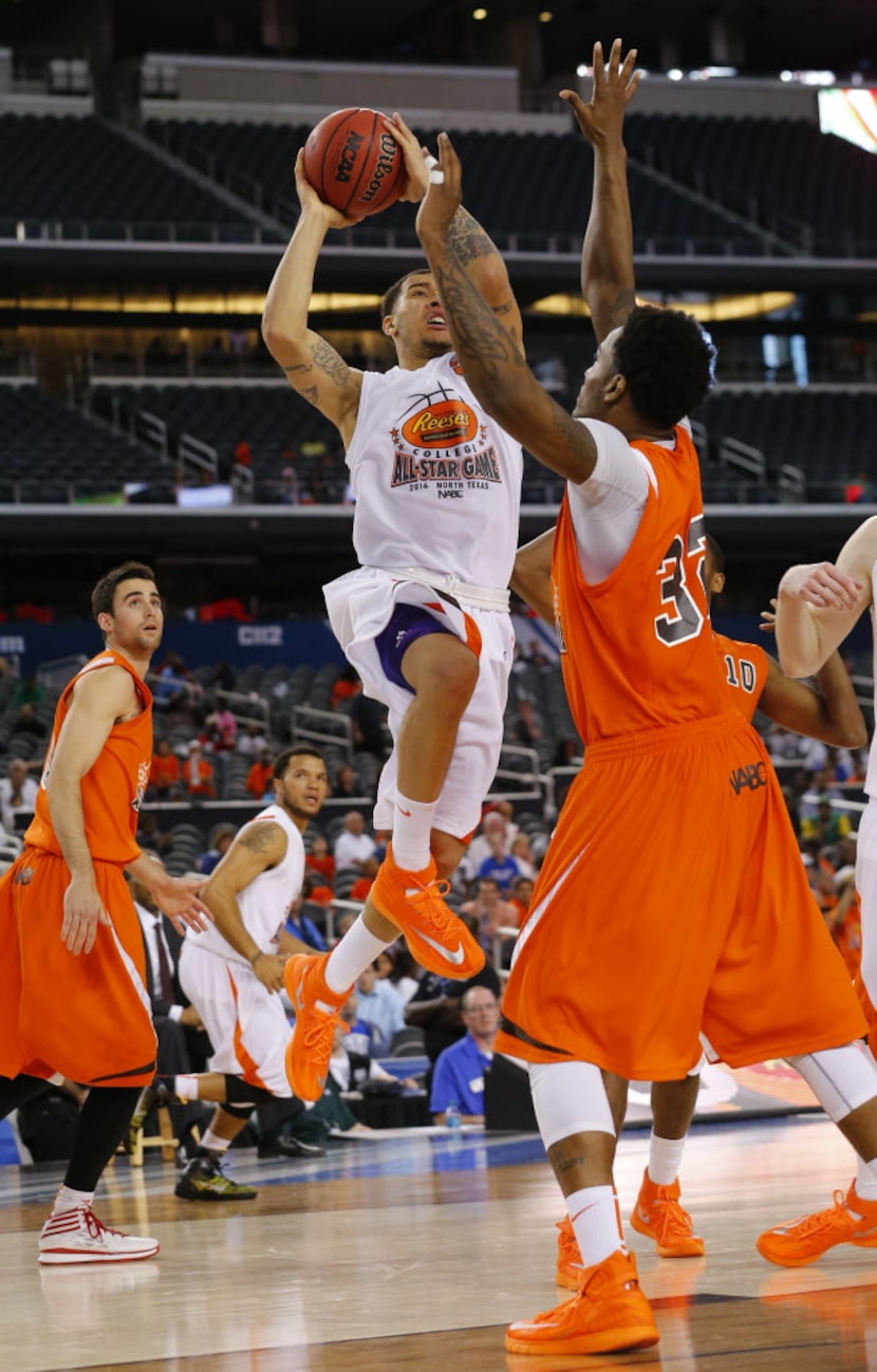 West guard Davian Berry (5) of Weber St. drives to the hoop against East forward Juvonte...