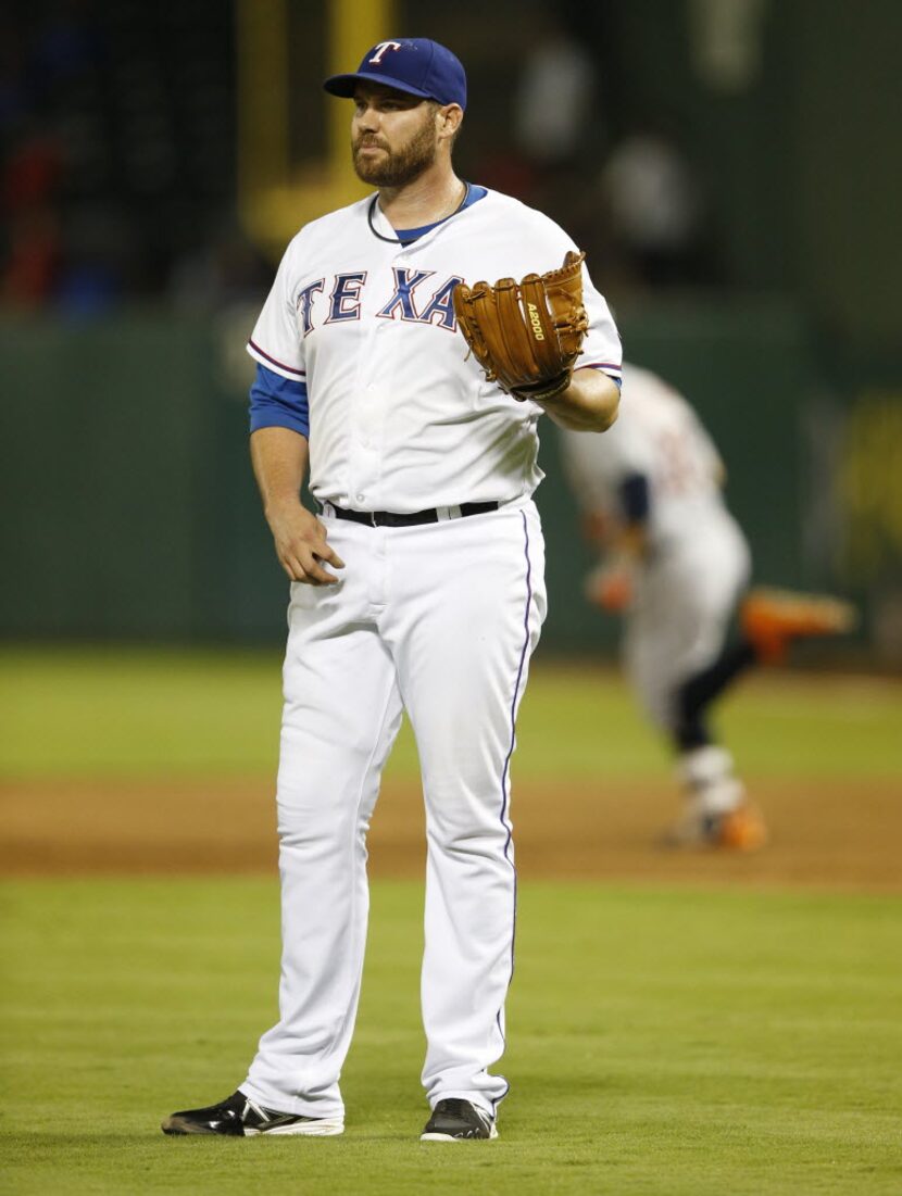 Texas Rangers starting pitcher Colby Lewis (48) after giving up a three run home run to...