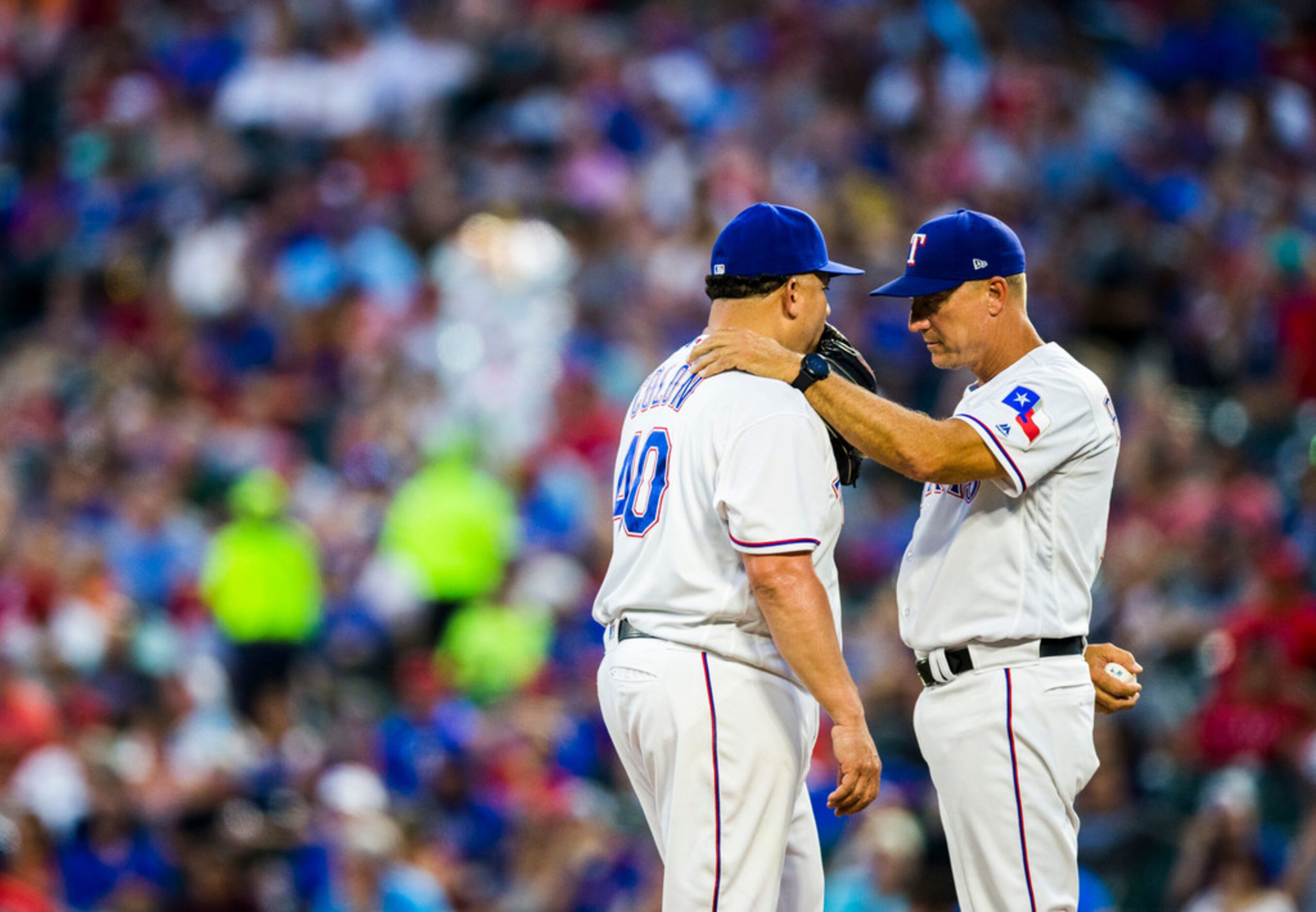 Texas Rangers manager Jeff Banister (28) takes the ball rom Texas Rangers starting pitcher...