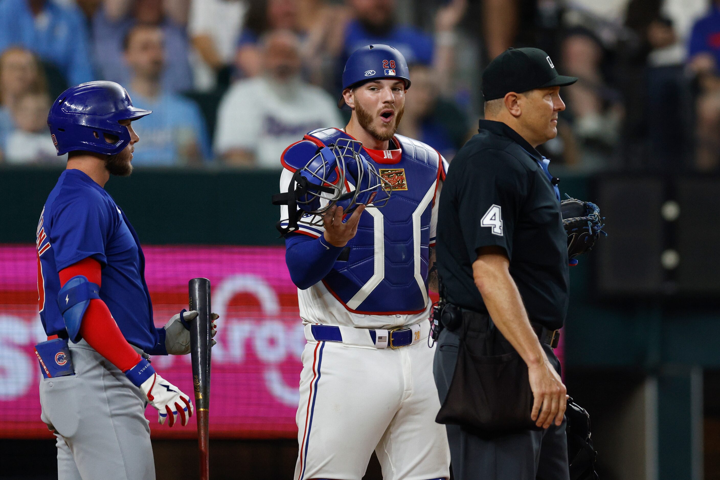 Texas Rangers catcher Jonah Heim (28) reacts after home plate umpire Chad Fairchild (4)...