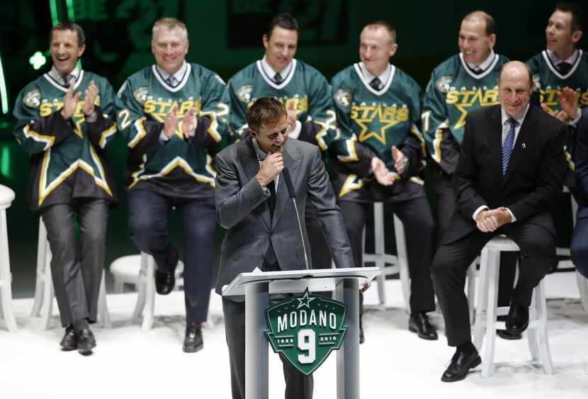 Mike Modano laughs during his speech during his jersey retirement ceremony at American...