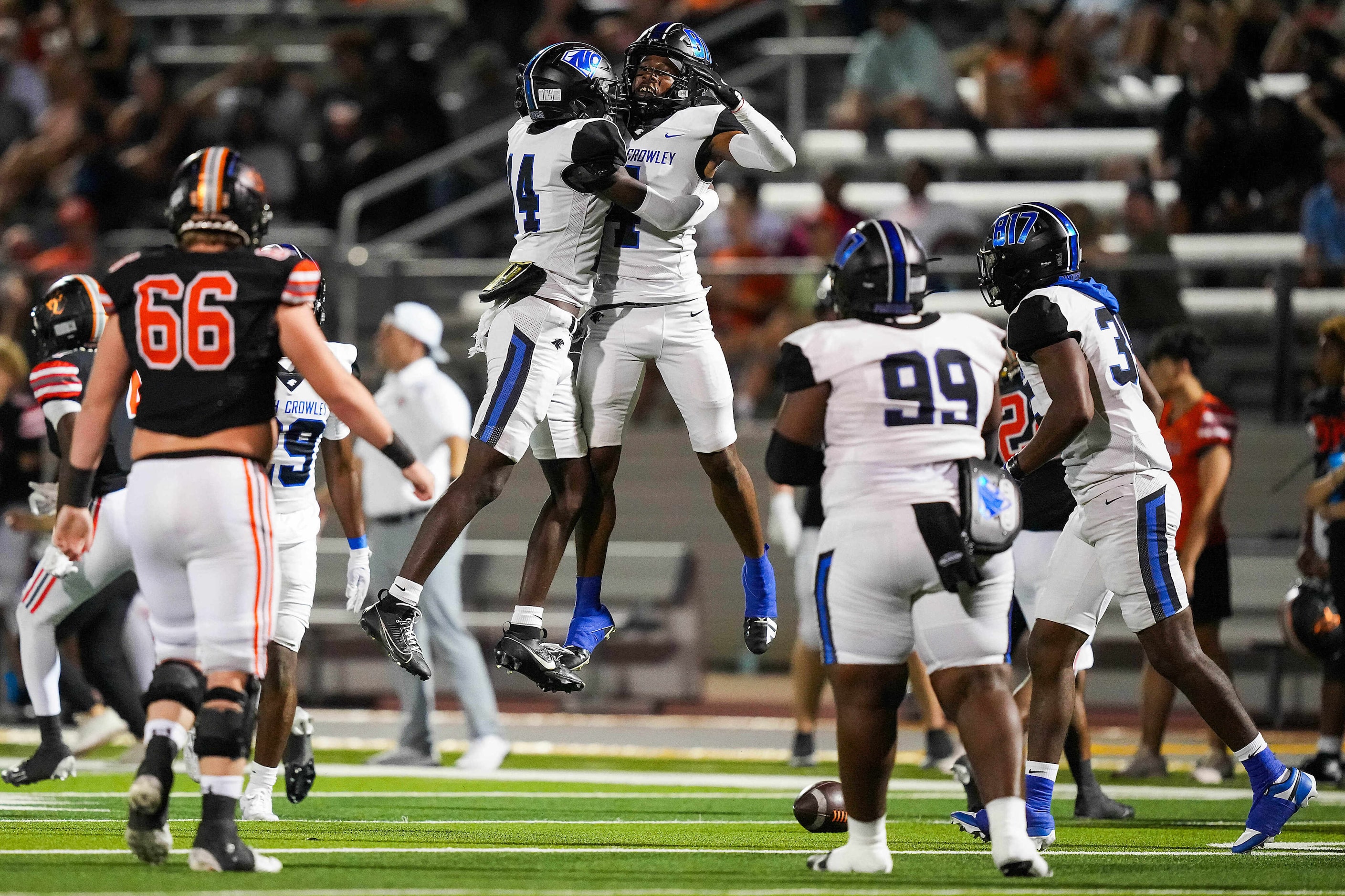 North Crowley running back Draden Fullbright (4) celebrates with Thomas Cook Jr. (14) after...