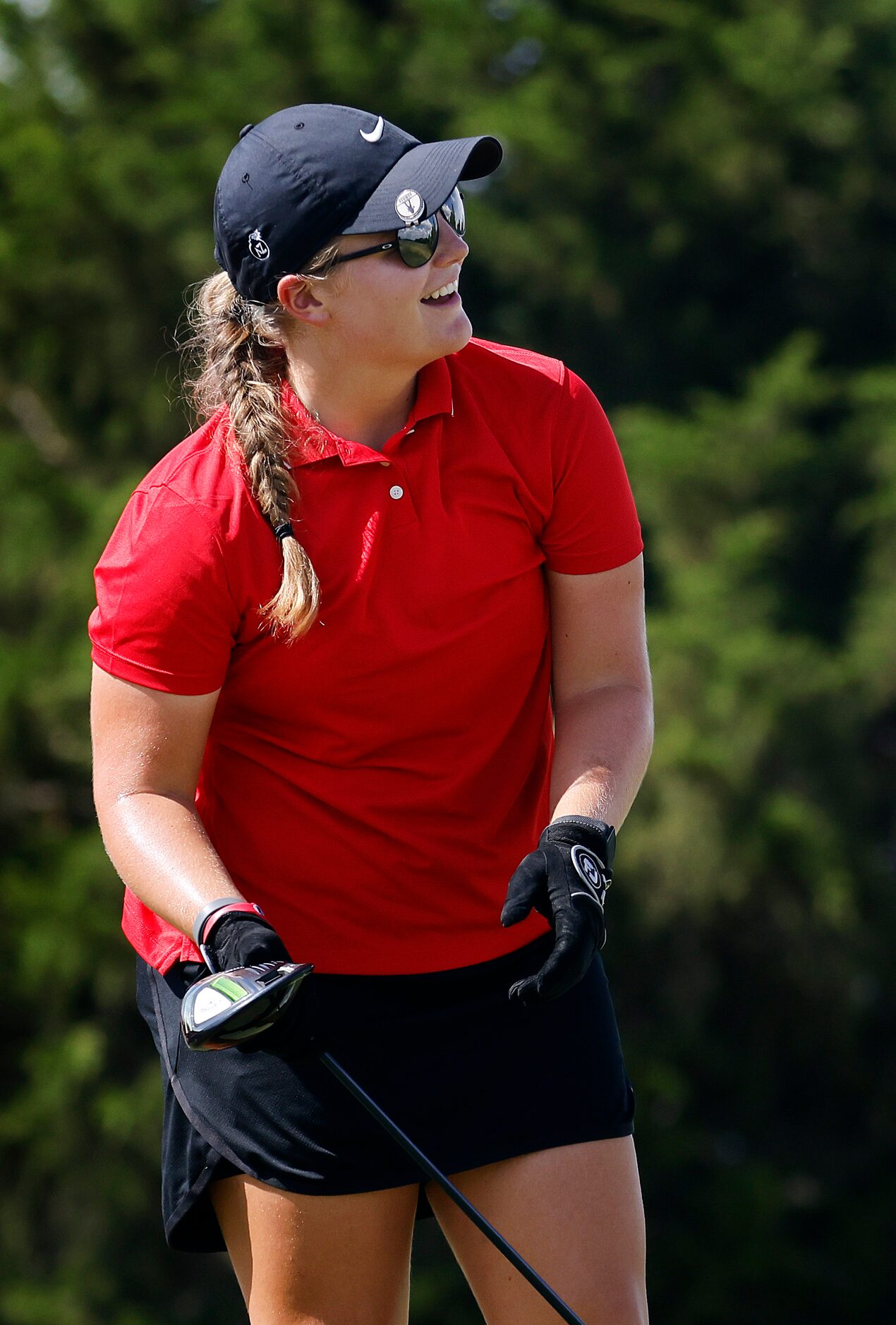 Amateur golfer Avery Zweig, 14, of McKinney reacts to her drive of the No. 10 tee box during...