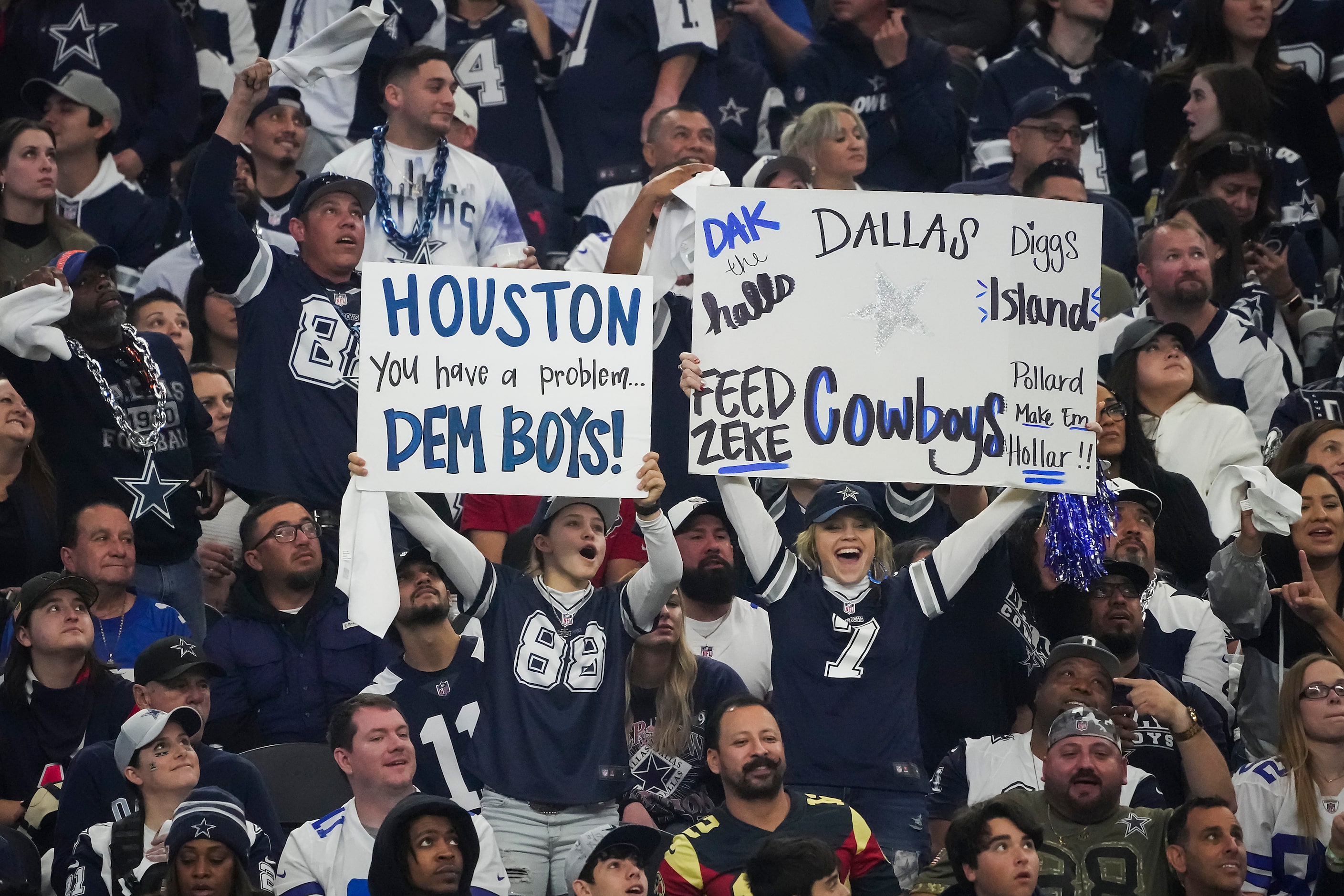 Dallas Cowboys fans cheer their team during the first half of an NFL football game against...