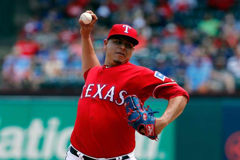 Texas Rangers' Ariel Jurado works against the Seattle Mariners during a baseball game in...