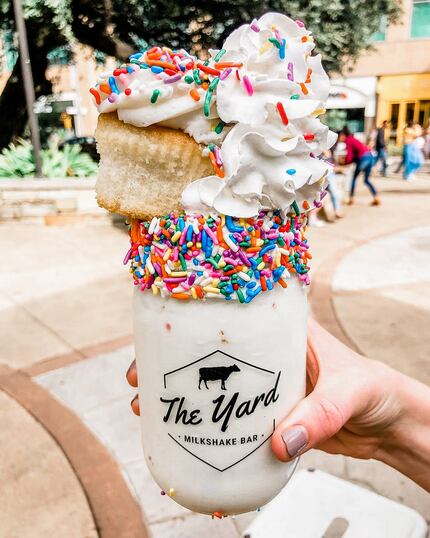 The Yard sells eye-catching milkshakes topped with cupcakes, doughnuts and bright colors.