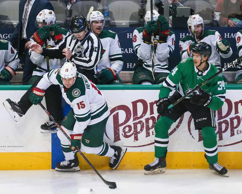 Minnesota Wild center Matt Hendricks (15) breaks past Dallas Stars right wing Denis Gurianov...