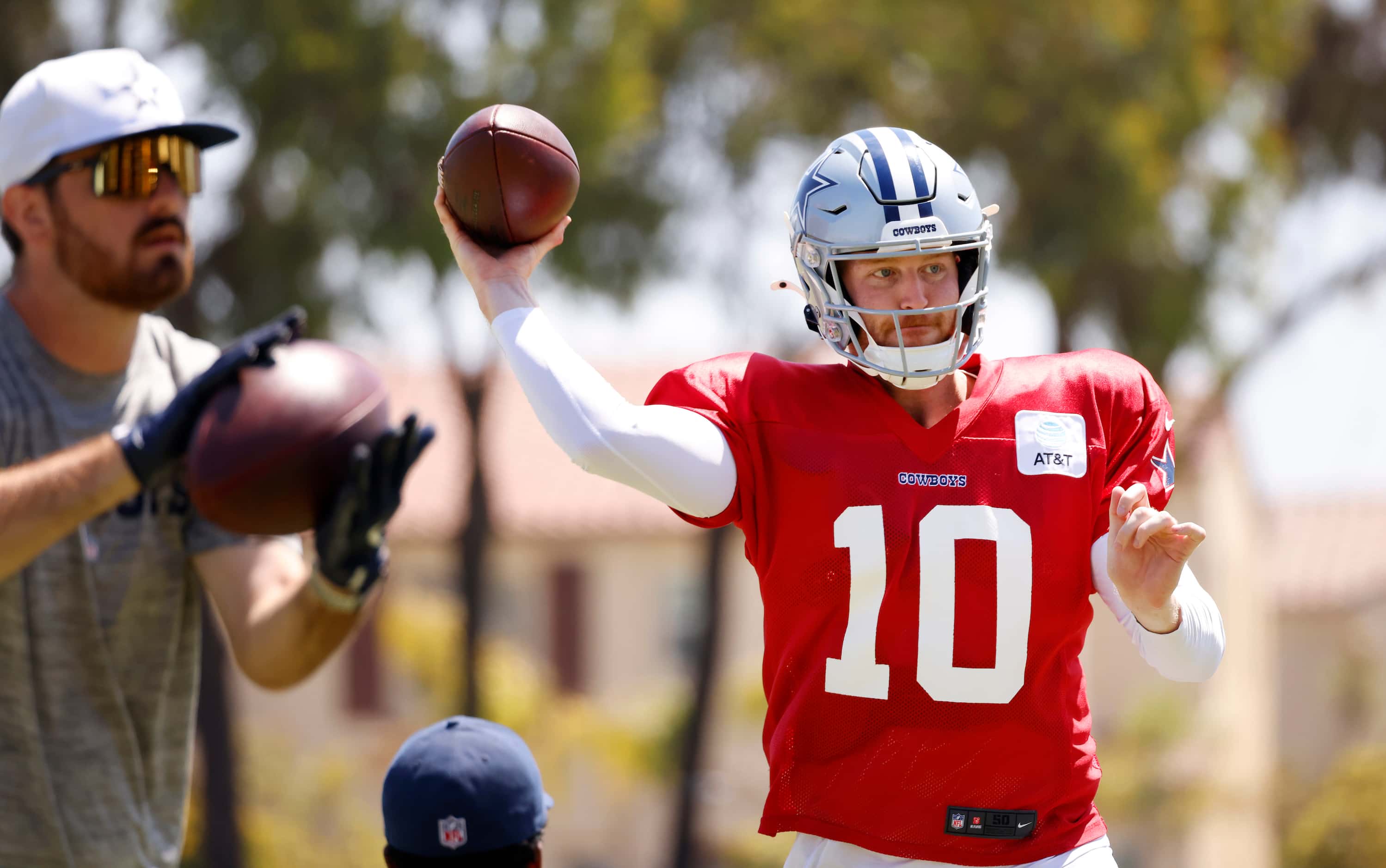 Dallas Cowboys quarterback Cooper Rush (10) throws to a target as he and tho other...