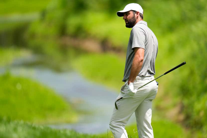 Scottie Scheffler waits to play on the second hole during the third round of the PGA...