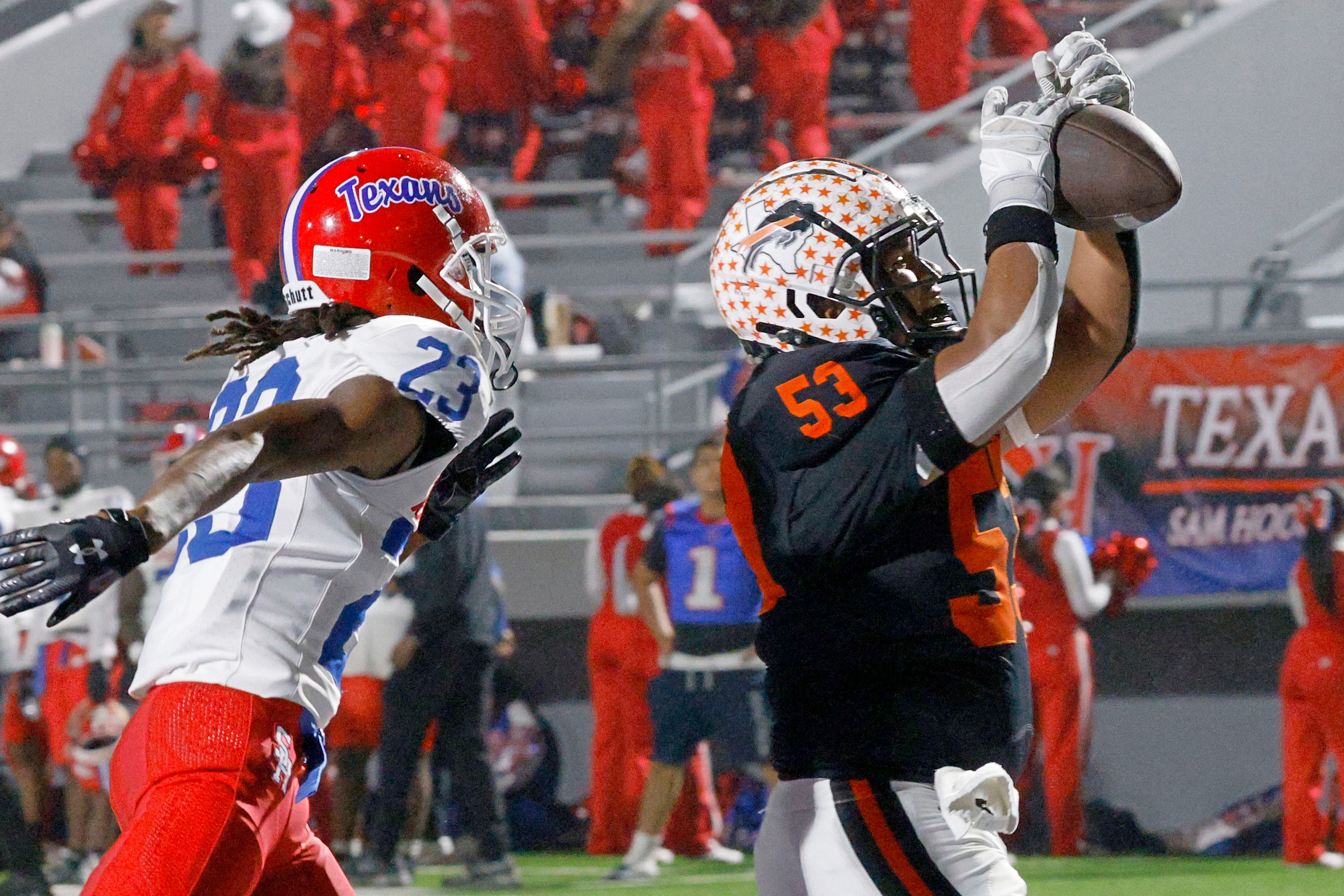 Haltom's Angel Padilla (53) scores a touchdown over Sam Houston's Emmanuel Thomas (23) in...