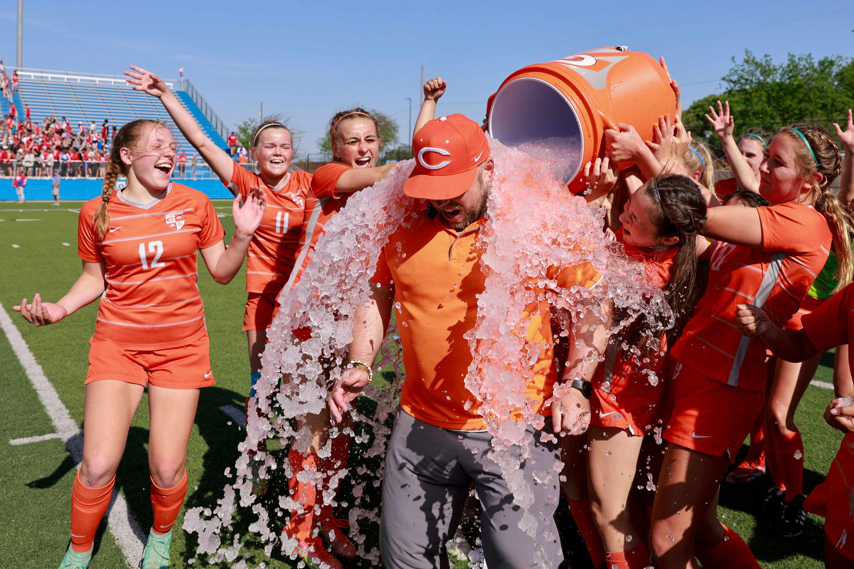 Celina players dose Celina head coach Alexander Adams with water after winning the Class 4A...