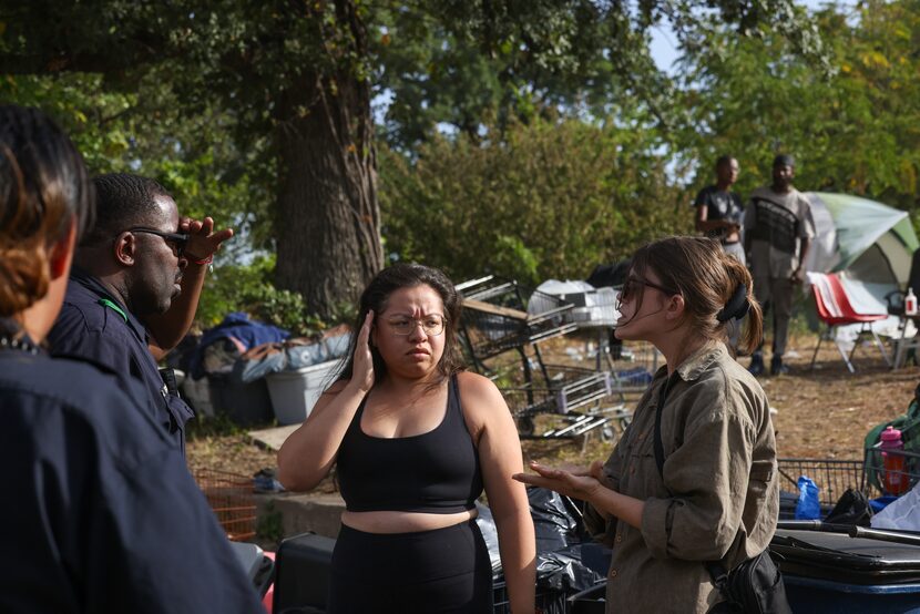 Kaitlin Siebert and Julia Paramo (center) spoke with Dallas marshal officers in front of the...