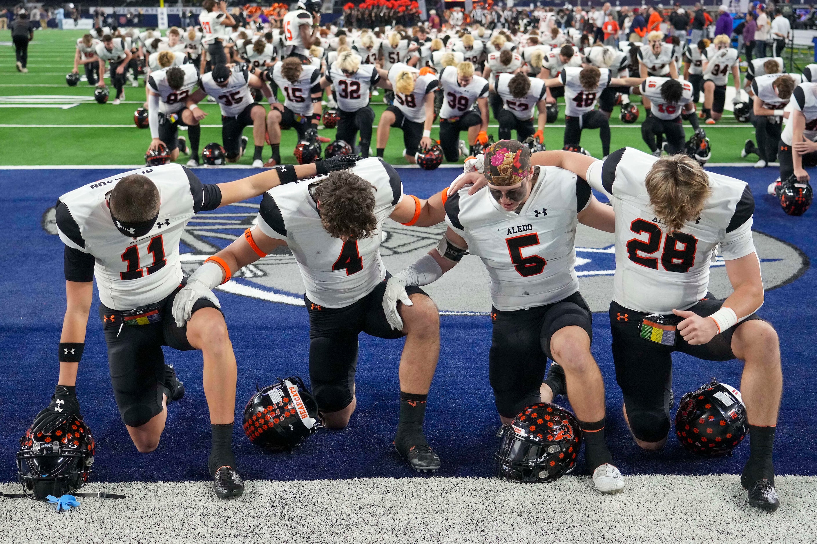 Aledo’s Trace Clarkson (11), Cooper Kohan (4), Ky Howington (5) and Zach Reilly (28) kneel...