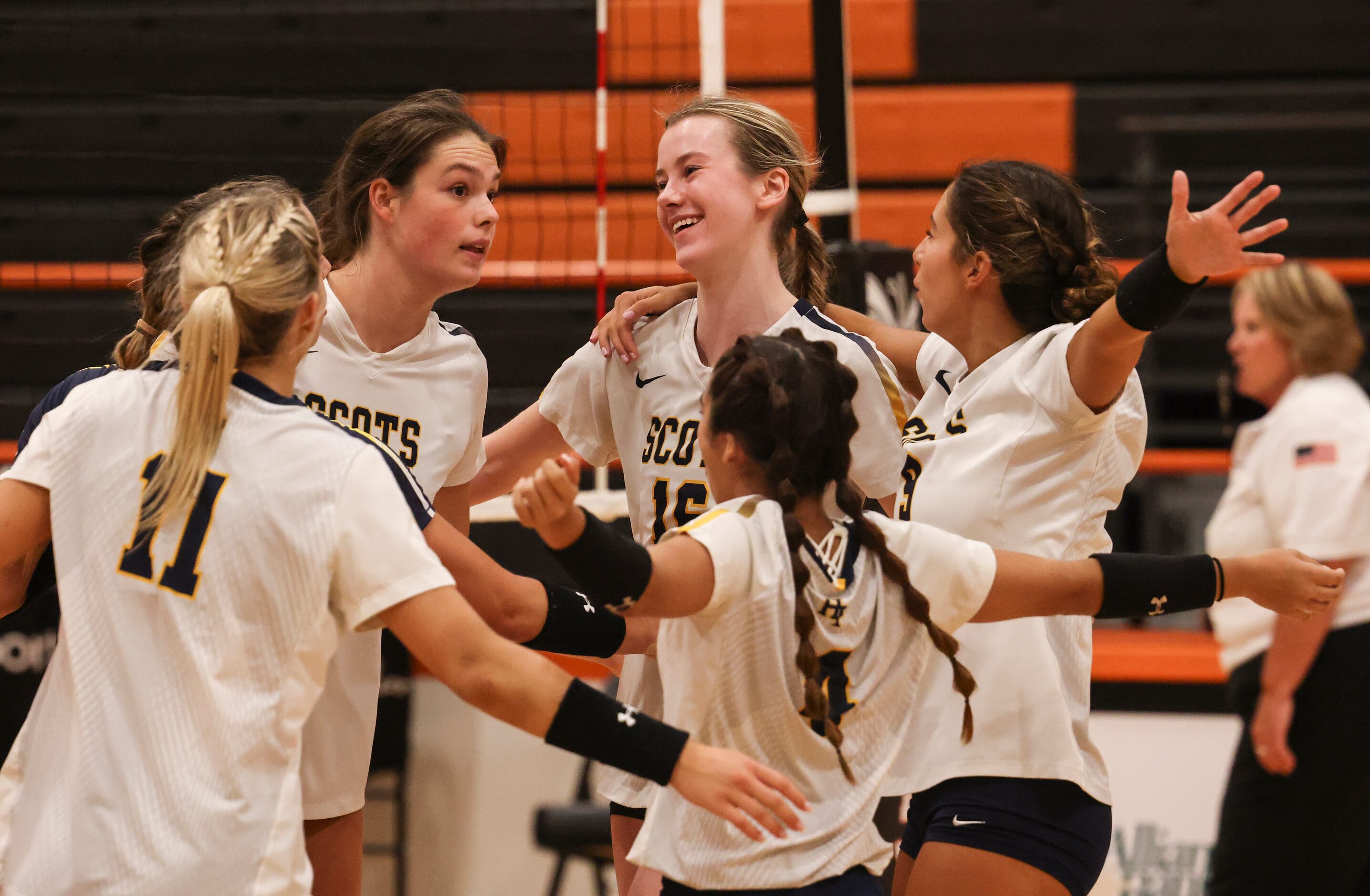 Highland Park High School players celebrate after winning a volley during the volleyball...