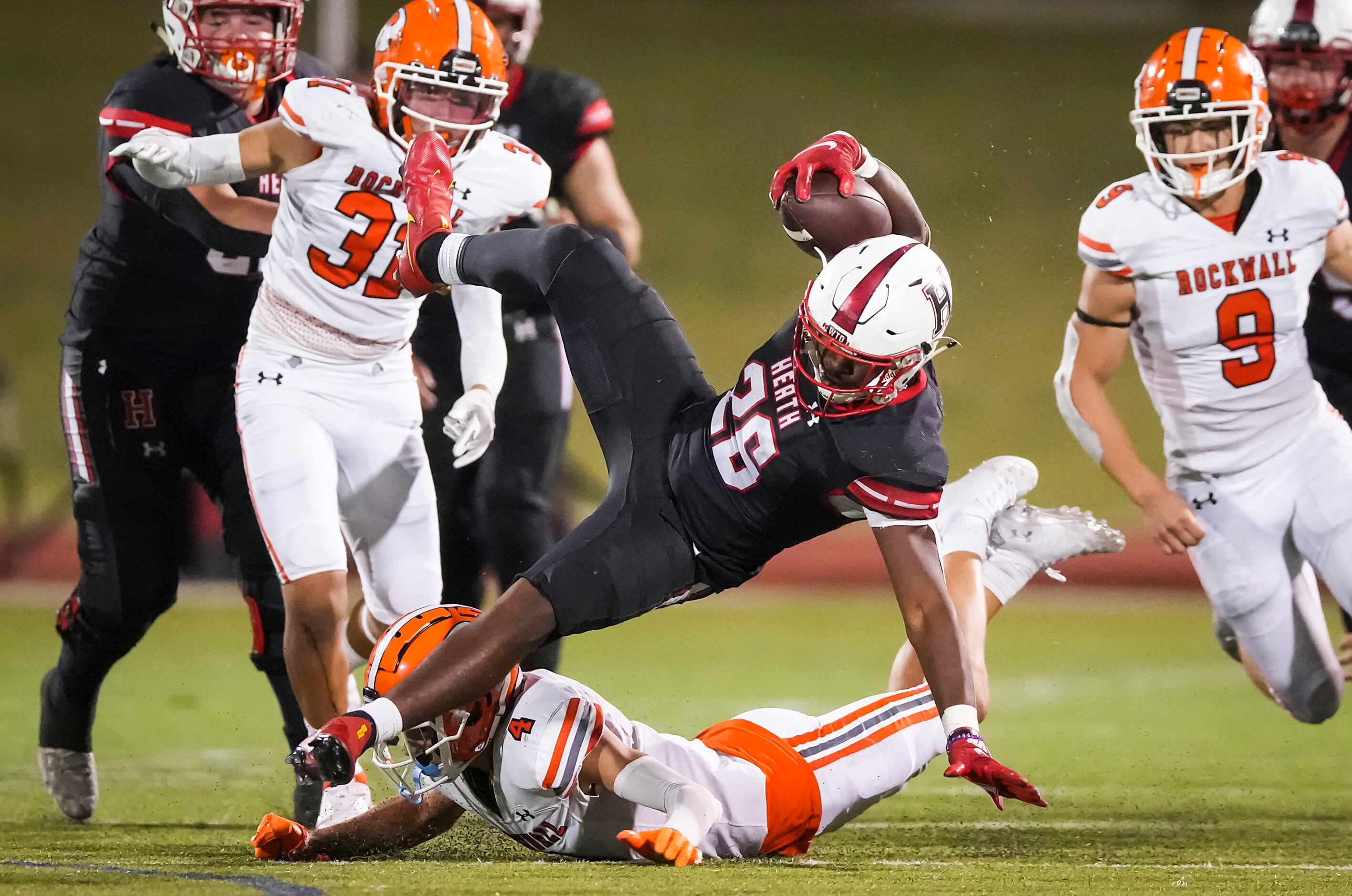 Rockwall-Heath running back  Zach Evans (26) is knocked off his feet by Rockwall defensive...
