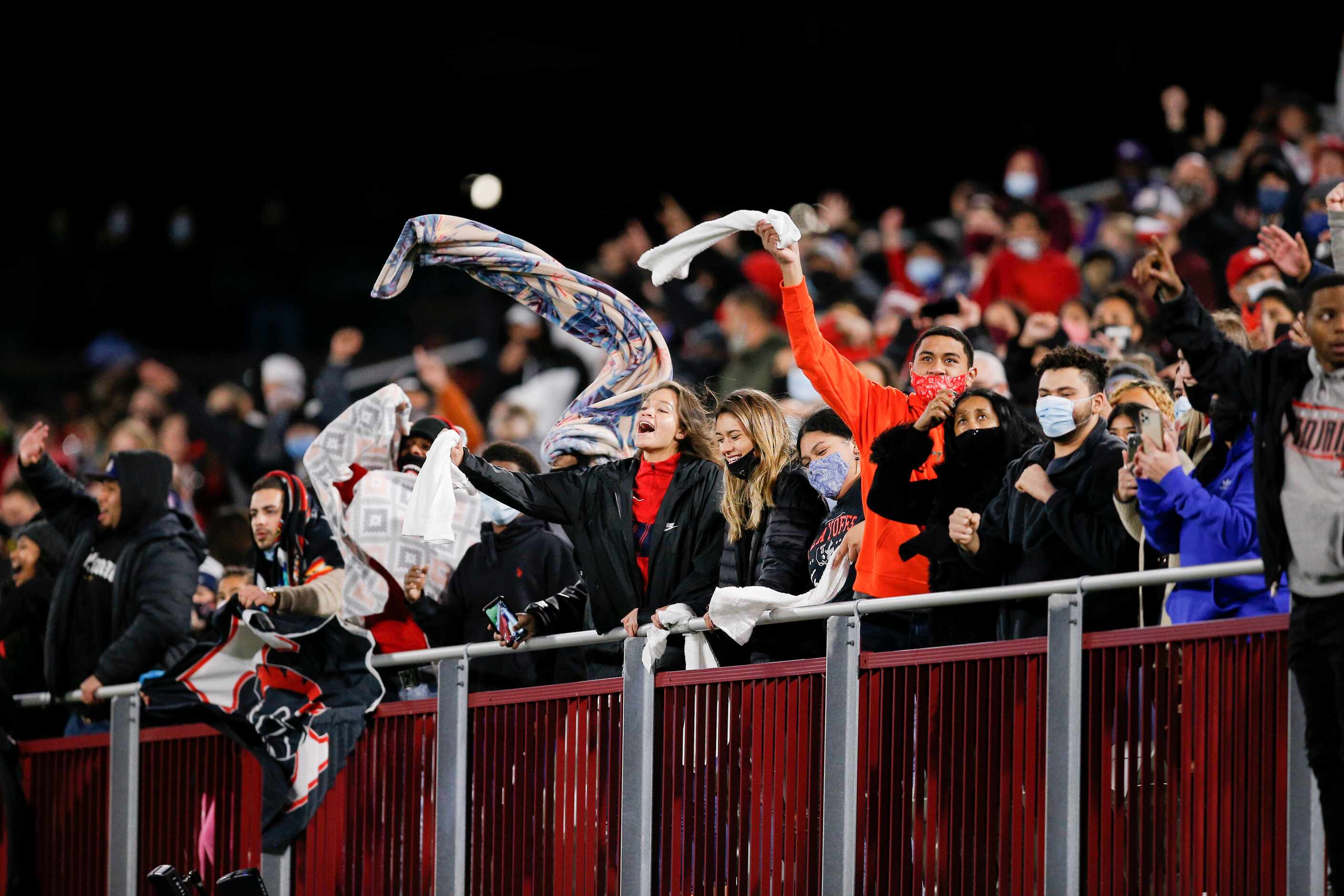 Euless Trinity fans celebrate during the second half of a high school Class 6A Division I...