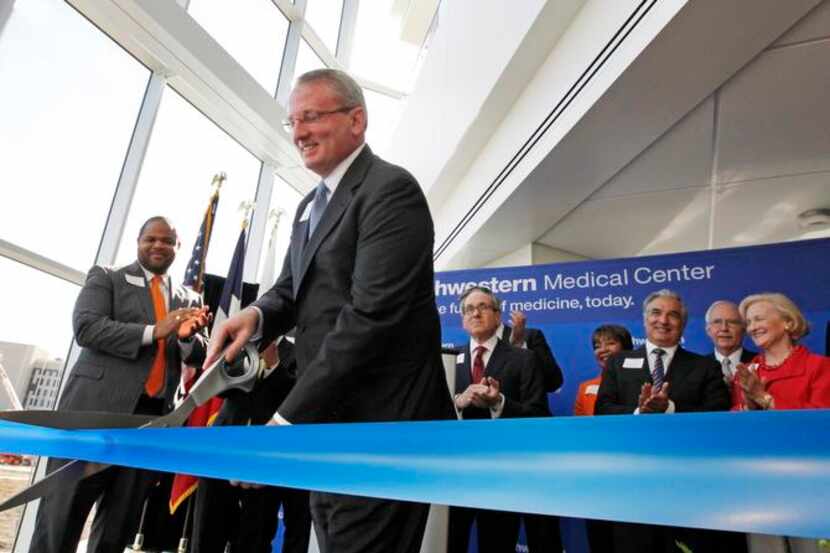 
Dr. John Warner cut a ribbon during the dedication ceremony of William P. Clements Jr....