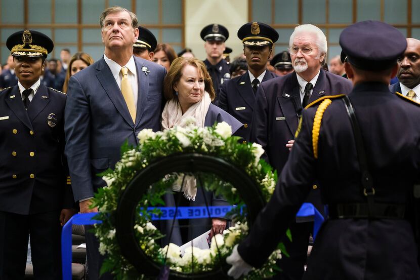 Dallas Mayor Mike Rawlings stands with wife Micki behind a wreath during the Dallas Police...