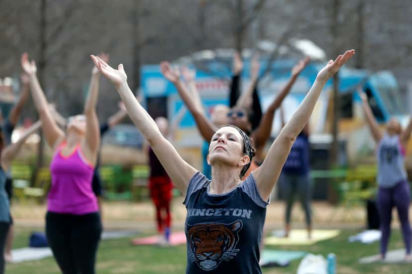 Kathy Kwart of Euless works out  during a free yoga class recently at Klyde Warren Park.