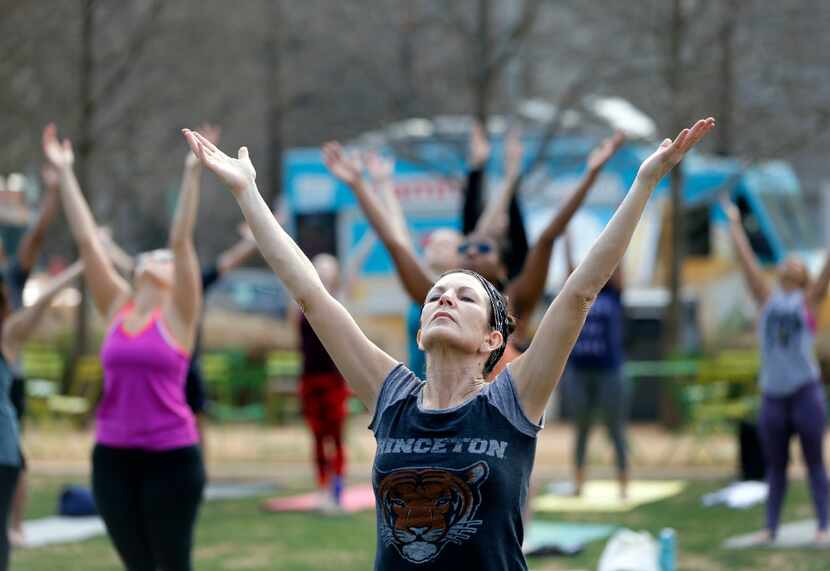 Kathy Kwart of Euless works out  during a free yoga class recently at Klyde Warren Park.