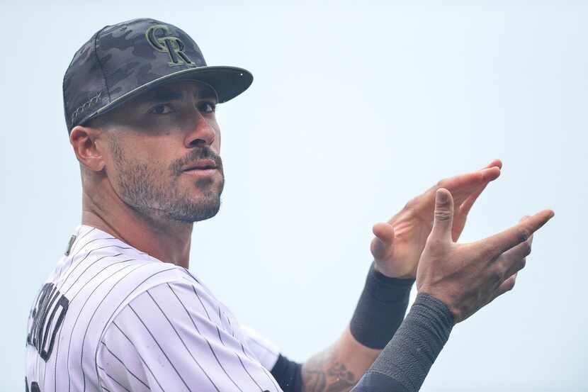 DENVER, CO - JULY 15: Ian Desmond #20 of the Colorado Rockies claps as members of the armed...