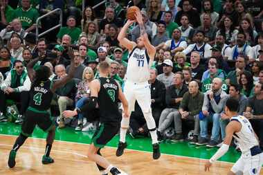 Dallas Mavericks guard Luka Doncic (77) hits a 3-pointer over Boston Celtics guard Jrue...