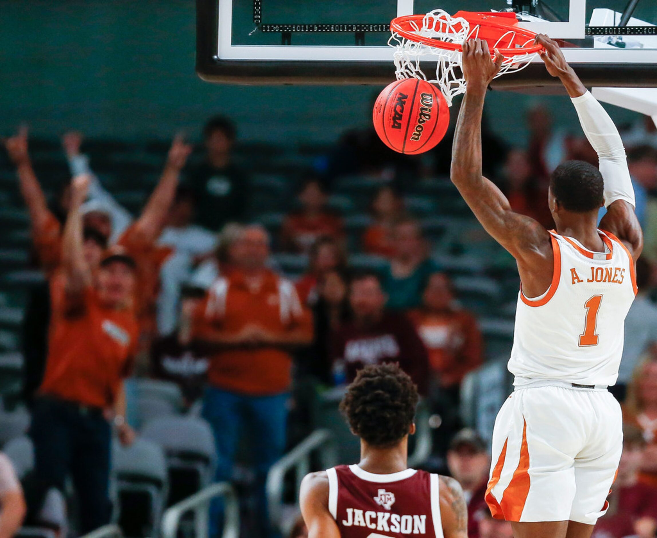 Texas Longhorns guard Andrew Jones (1) dunks over Texas A&M Aggies guard Quenton Jackson (3)...