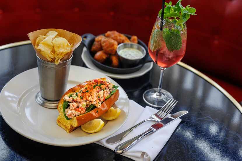 A lobster roll, beer battered redfish beignets with Hugo spritz at Walloon’s Restaurant in...