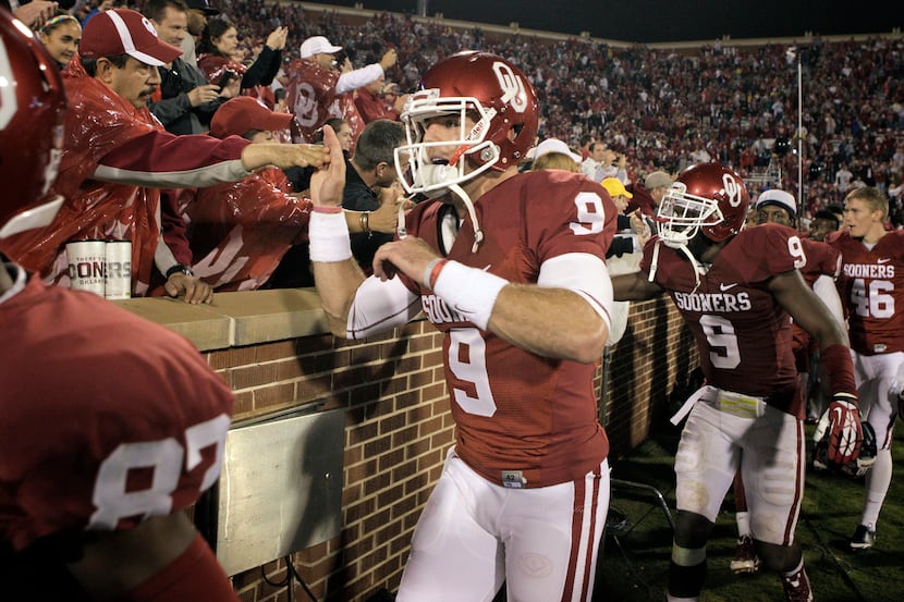Quarterback Trevor Knight #9 of the Oklahoma Sooners celebrates with fans after the game...
