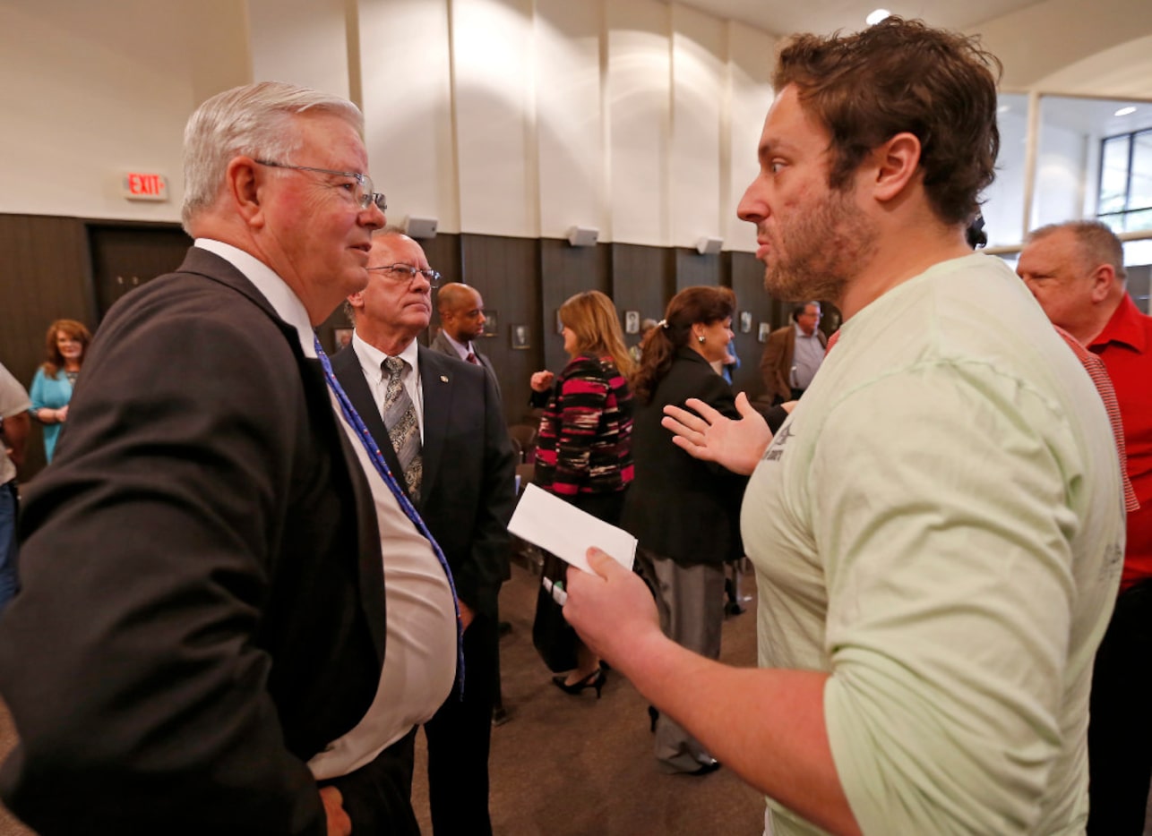 Rep. Joe Barton (left) talks with Harry Phillips after a town hall meeting at Corsicana...