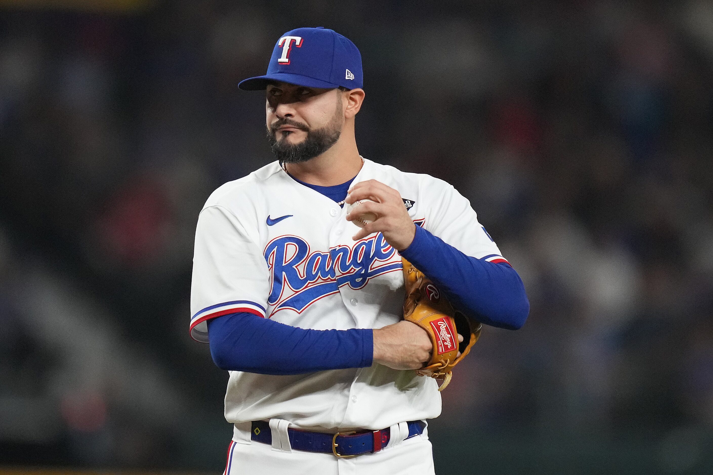 Texas Rangers pitcher Martin Perez reacts after walking Arizona Diamondbacks pinch hitter...