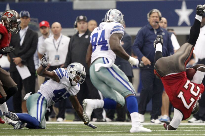 Tampa Bay Buccaneers running back LeGarrette Blount (27) falls awkwardly after getting up...